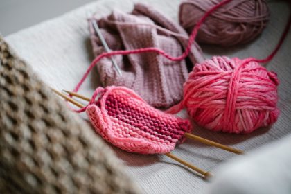 Close-up of knitting project with pink yarn and needles