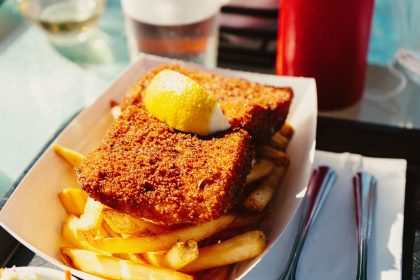 A close-up of crispy fish and chips with a lemon wedge, perfect for a delicious meal.