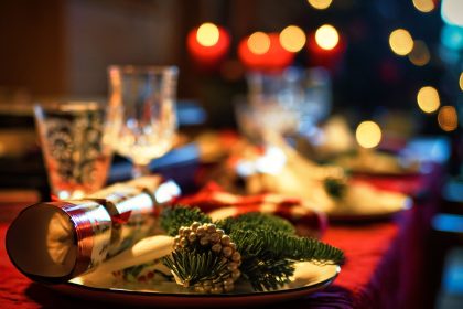 Elegant Christmas table setting adorned with festive decor and candlelight ambiance.