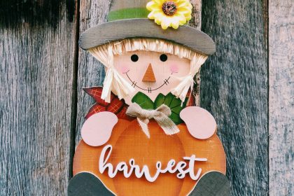 Cute scarecrow decor against rustic wood, perfect for autumn harvest themes.