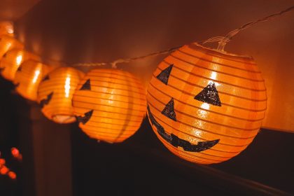 Close-up of festive Halloween pumpkin lantern string lights indoors.