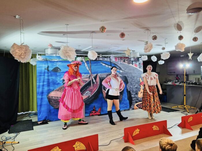 Residents enjoying a live pantomime performance at Beeston Rise, with performers in colourful costumes entertaining the audience.