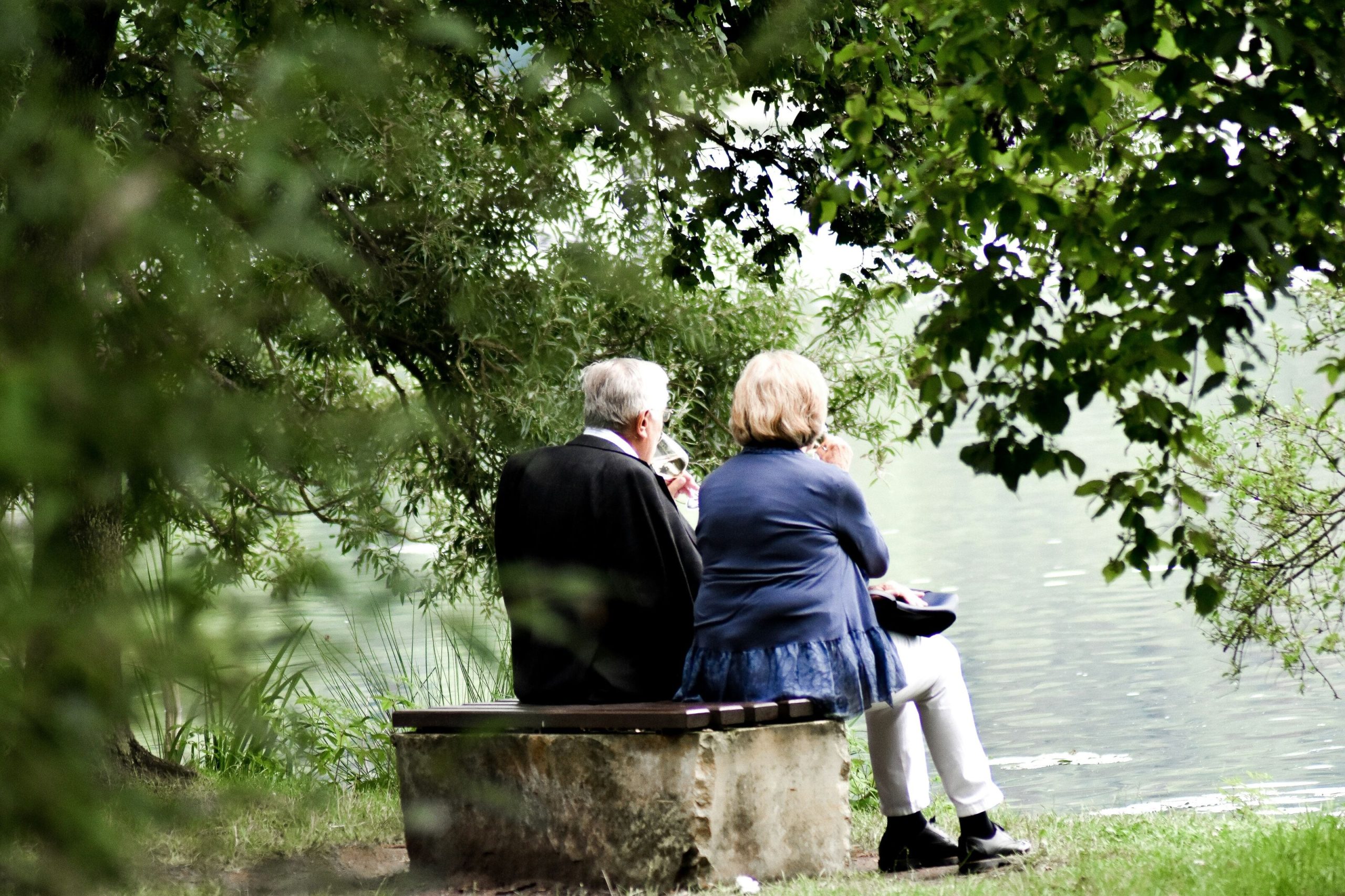 elderly couple sitting in the serene countryside, emphasising the role of relationships in person-centred care within dementia.