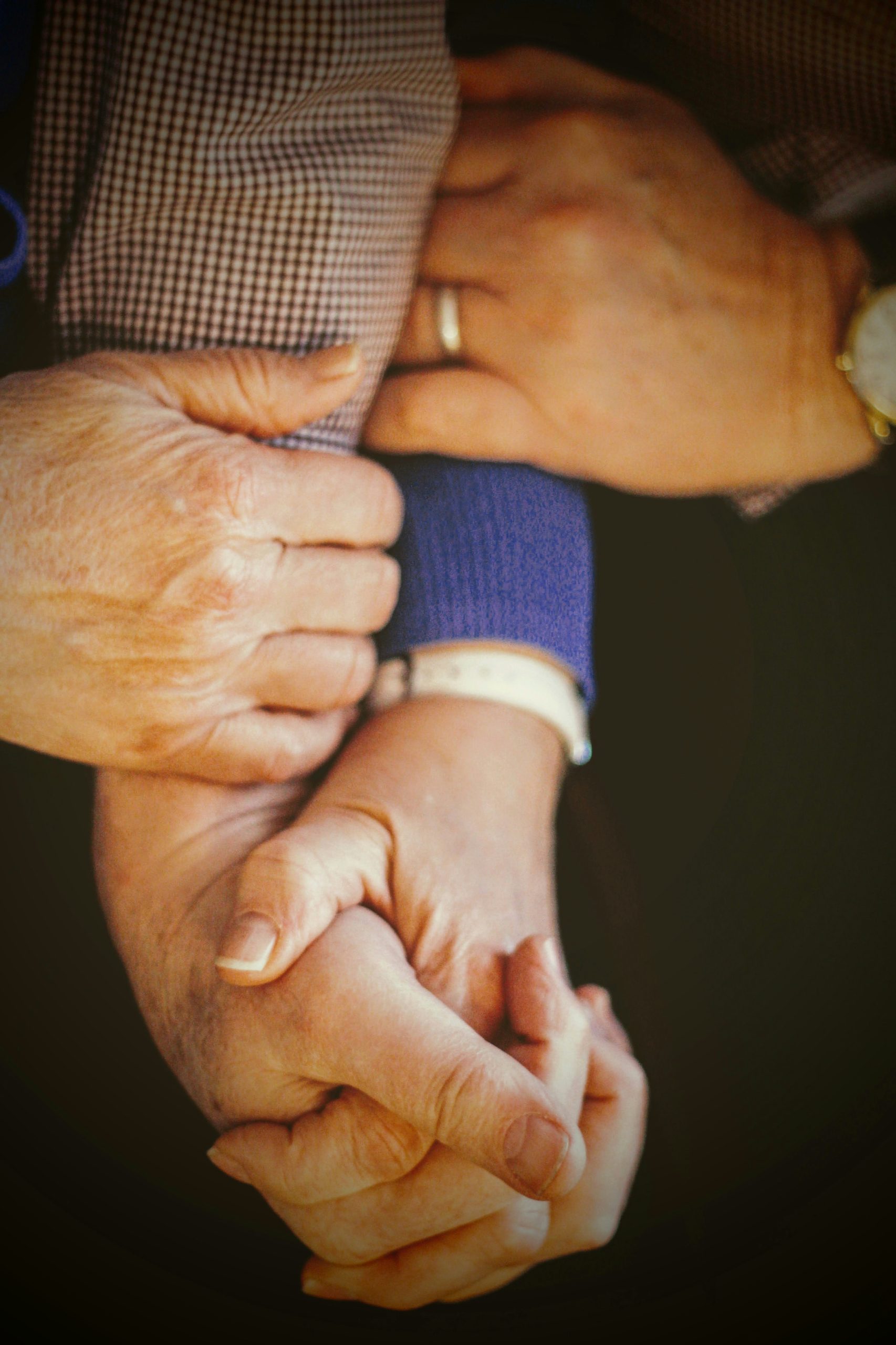elderly couple holding hands