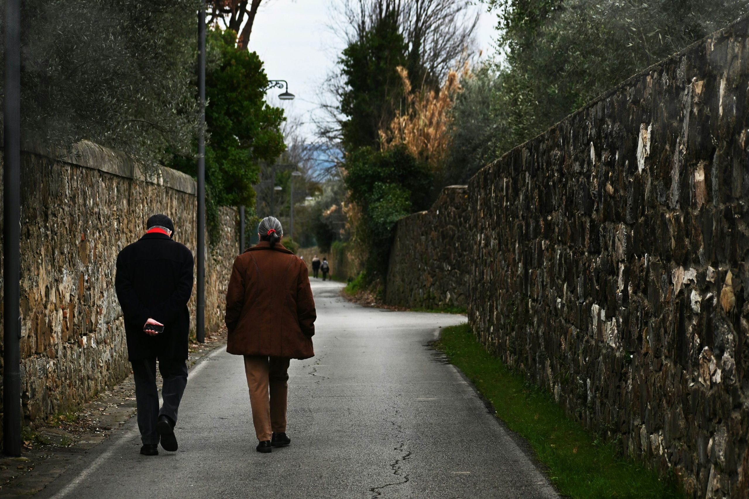 elderly couple walking outside in nature