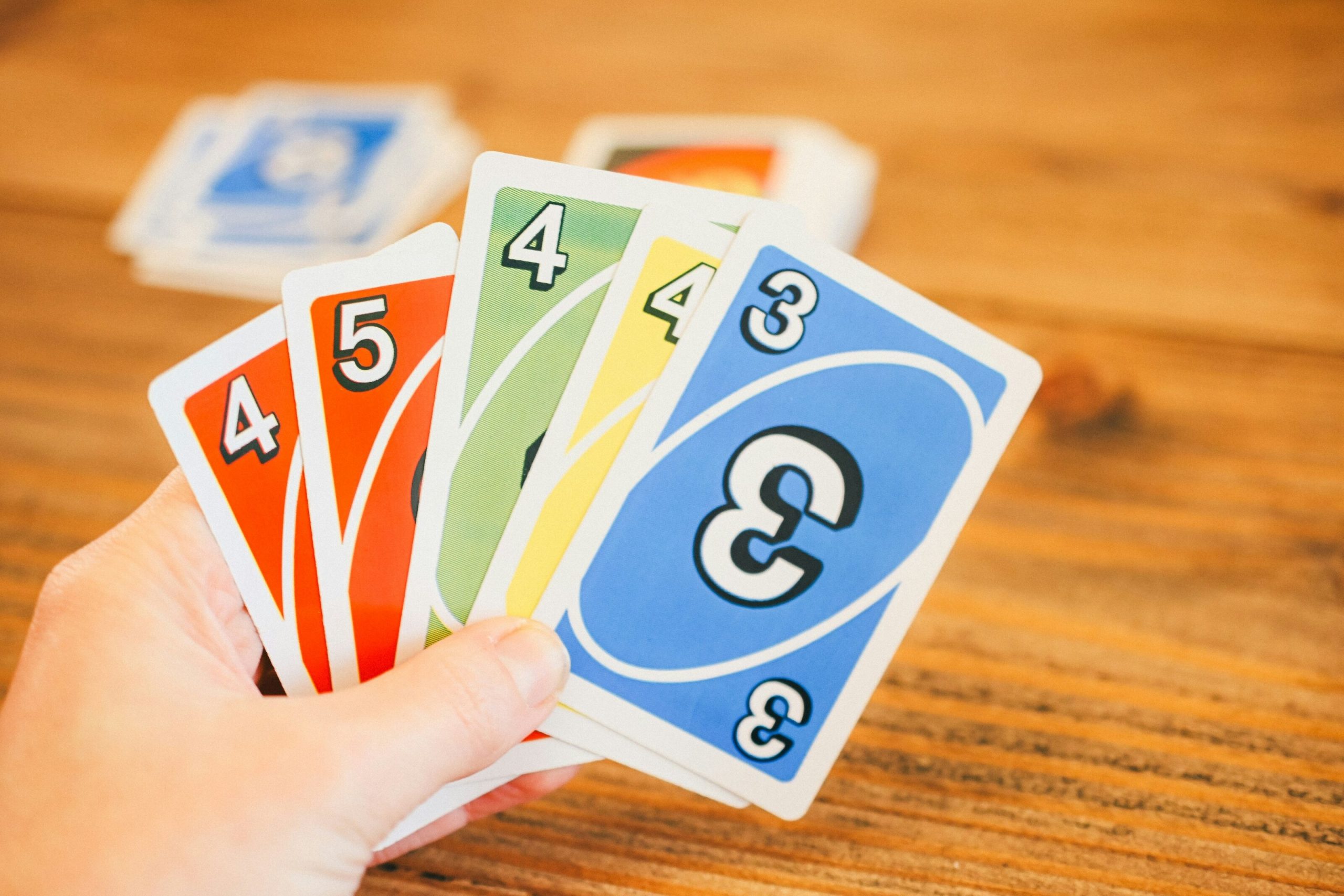 elderly resident holding UNO cards