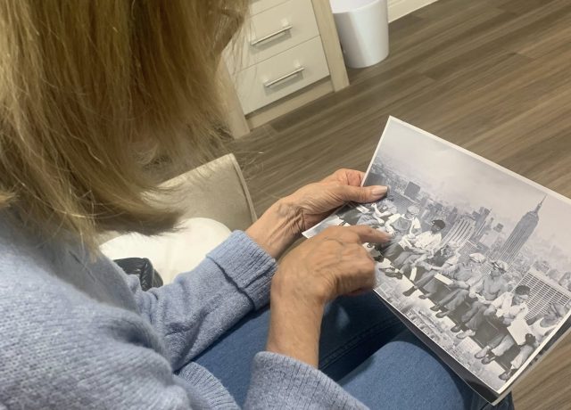 Bingley park care home resident looking at a photograph in celebration of National Photography Day