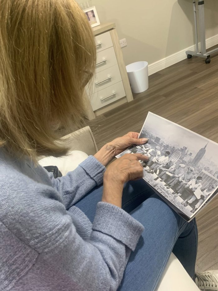 Bingley park care home resident looking at a photograph in celebration of National Photography Day