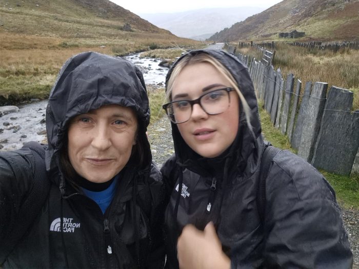 Two Beeston Rise team members hiking on Mount Snowdon during a charity climb to raise funds in memory of a resident.