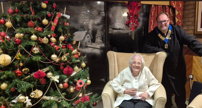 Toray Pines Care Home in Coningsby resident Gwen next to Christmas tree