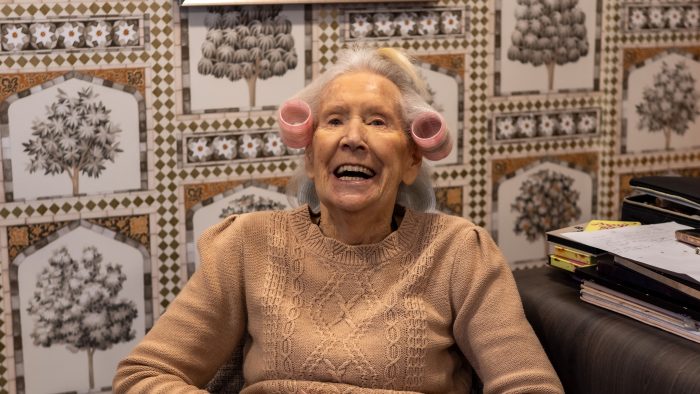 A smiling resident enjoying a pampering session at Trent Bridge residential home in Nottingham
