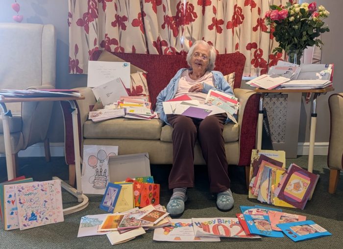 Resident Gwen on her 102nd birthday surrounded by some of the 400 birthday cards at Toray Pines care home in Lincoln 